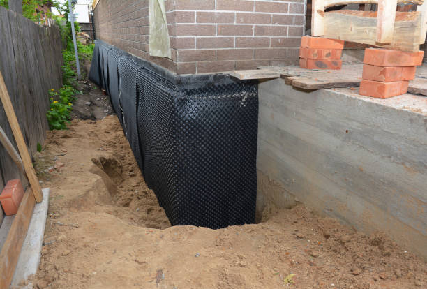 SJ Waterproofing Pros technician performing targeted Interior Drainage System assessment in Commerce Township, MI